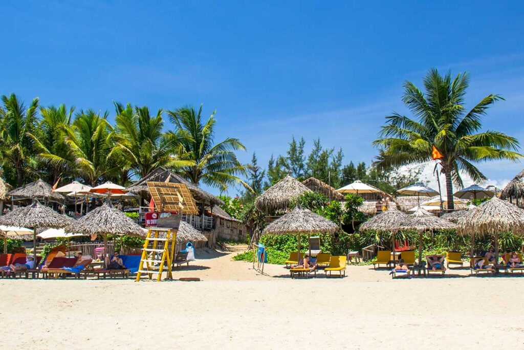 lounge chairs and palm trees on An Bang Beach near Hoi An