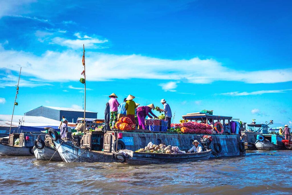 People selling goods from their boats at the Cai Rang Floating Market.