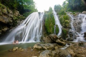 People swimming in the Go Lao waterfall Mai Chau