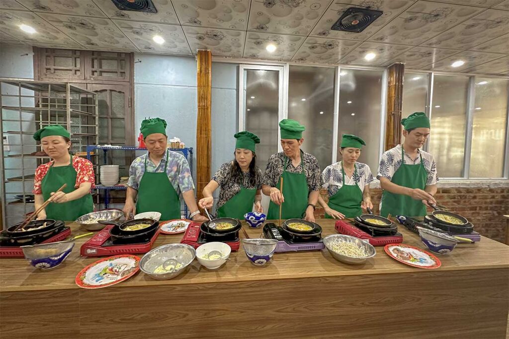 Group cooking Vietnamese pancakes at Hoi An Eco Cooking Tour