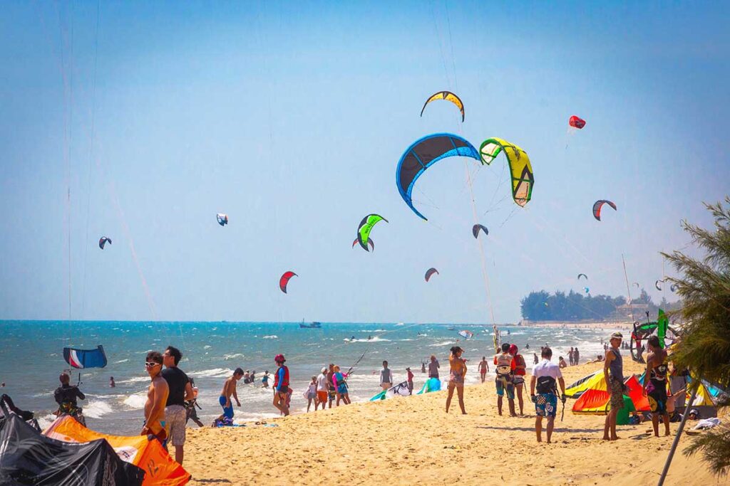 Many kite surfers at the beach of Mui Ne.