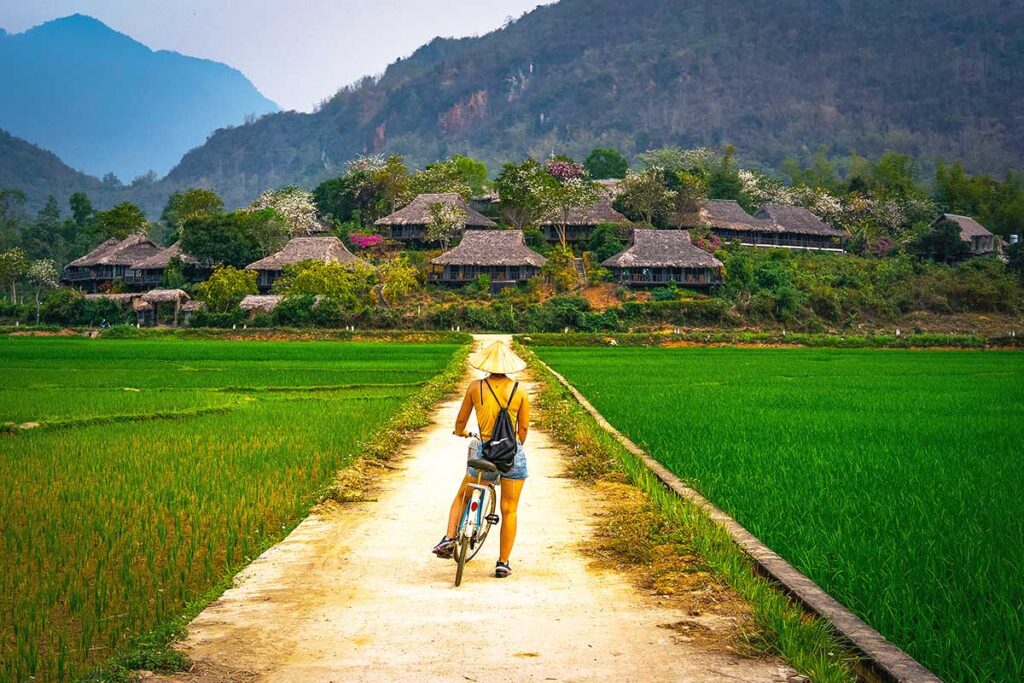 Cycling in Mai Chau countryside is one of the best things to do in Vietnam, featuring rice fields and local villages.
