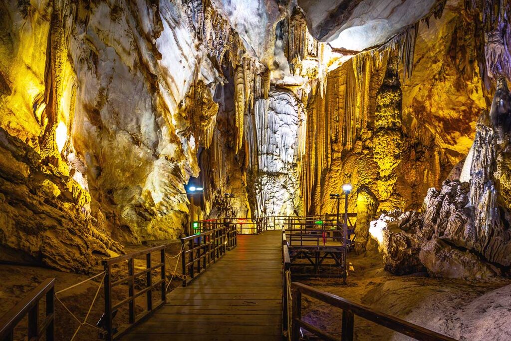 Inside Paradise Cave, part of Phong Nha-Ke Bang National Park, with well-lit stalactites and stalagmites and neatly laid walking paths.