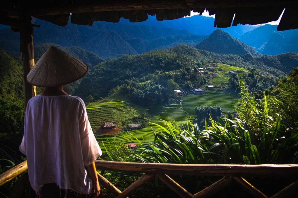 A woman with conical hat doing a Sapa homestay trekking