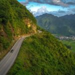 Steep section of the Thung Khe Pass with Mai Chay valley on the background seen from drone