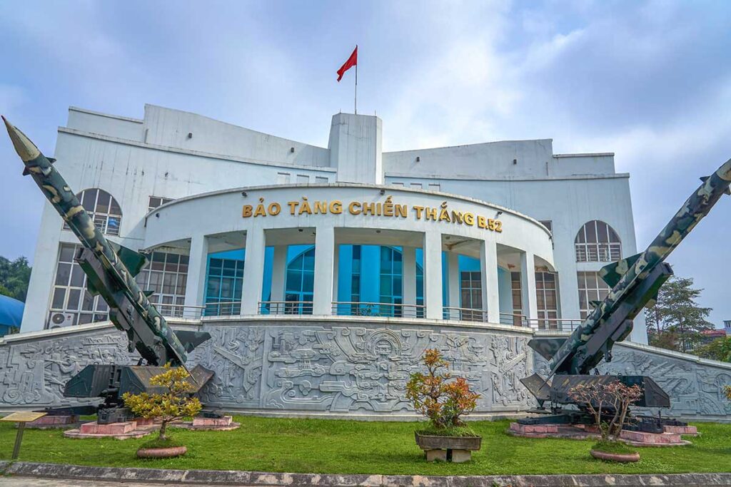 The front exterior of B52 Victory Museum with two SAM rockets displayed in the courtyard