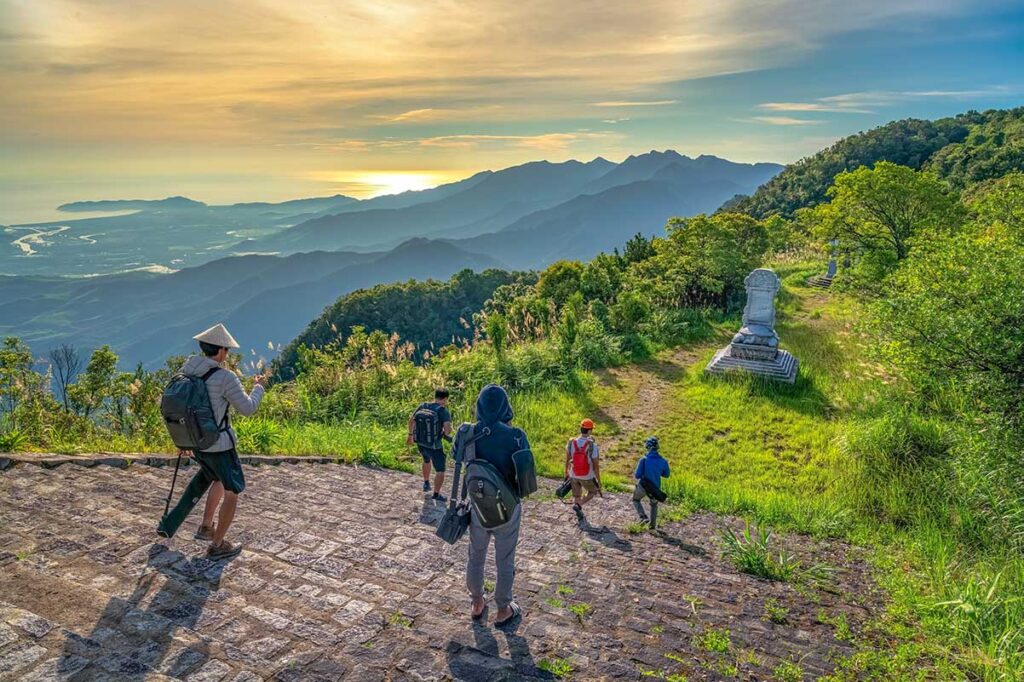 Trekking in Bach Ma National Park at the peak with views over the surrounding mountains and forests