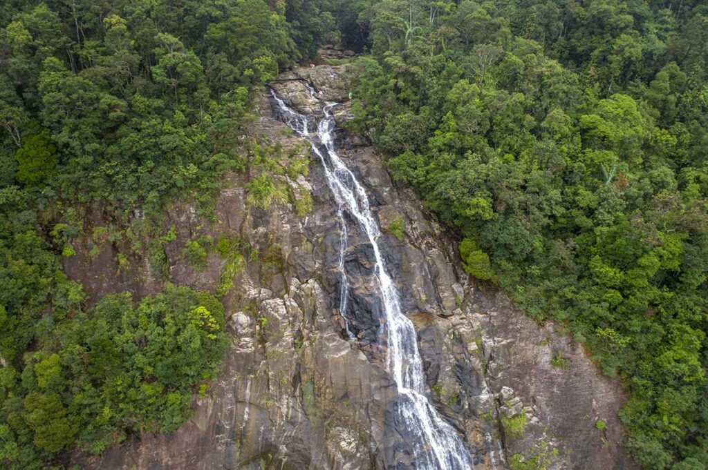 Aerial view of Do Quyen waterfall where a few travellers are on the top while doing a trekking in Bach Ma National Park