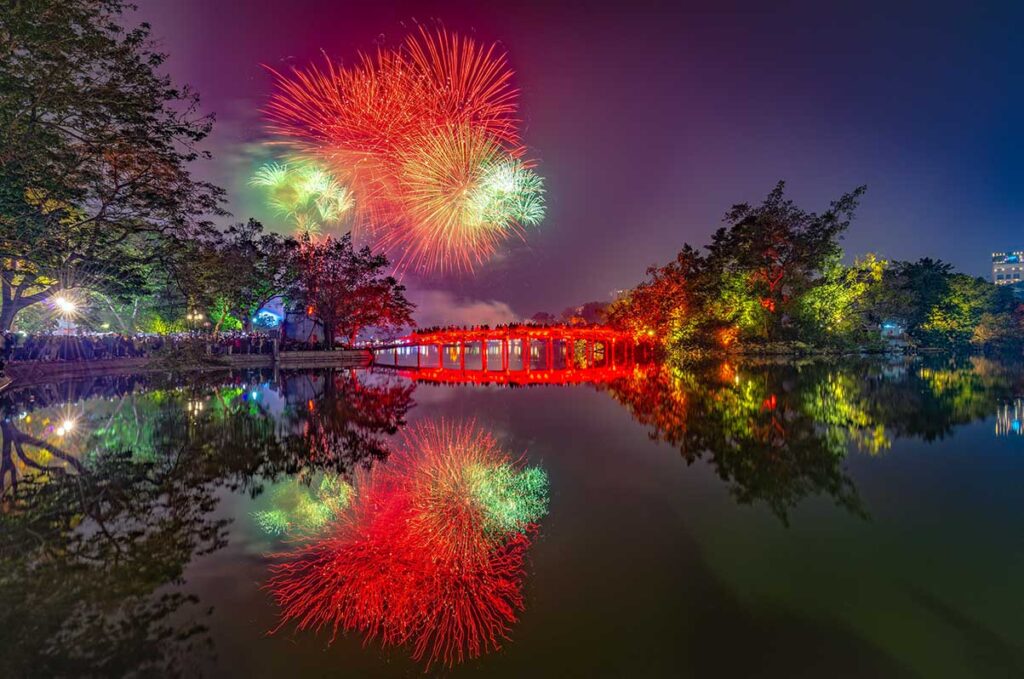 Fireworks above Hoan Kiem Lake and The Huc Bridge during celebrations for New Year in Hanoi (Western New Year) 31 December - 1 January
