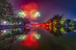 Fireworks above Hoan Kiem Lake and The Huc Bridge during celebrations for New Year in Hanoi (Western New Year) 31 December - 1 January