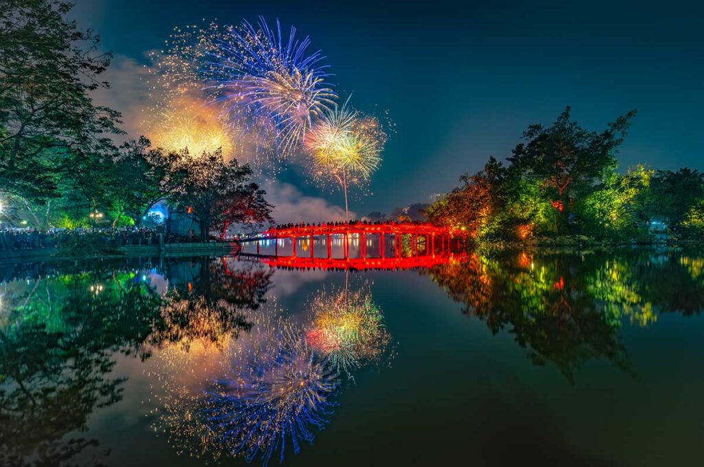 Fireworks above Hoan Kiem Lake and The Huc Bridge during celebrations for New Year in Hanoi (Western New Year) 31 December - 1 January