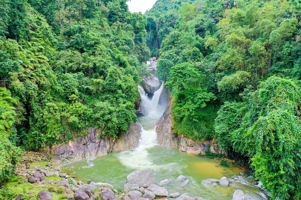 Waterfall in lush forest near the City of Ha Giang the start of the infamous Ha Giang Loop