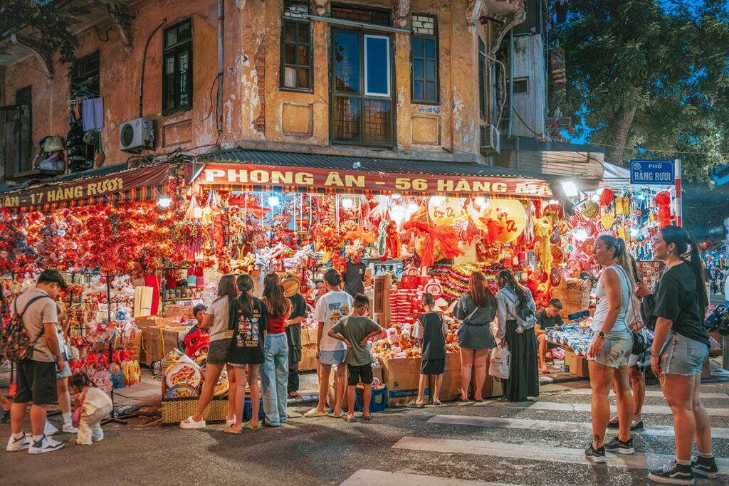 People shopping at a shop in Hang Ma Street in the Old Quarter that sells many decorations for Mid Autumn Festival in Hanoi