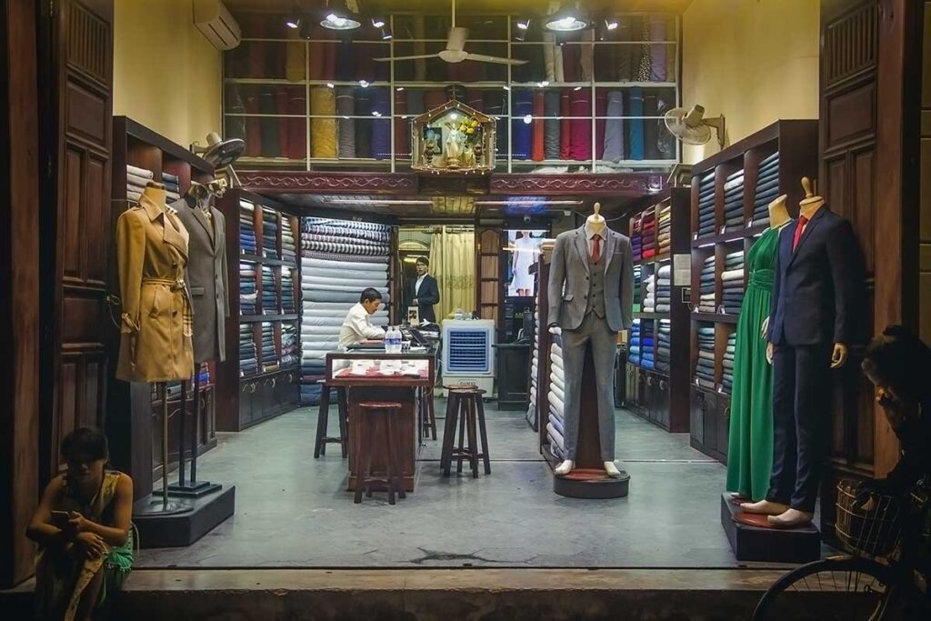 Elegant tailor shop in Hoi An with suits and dresses on display, offering professional fittings and custom made clothing services.