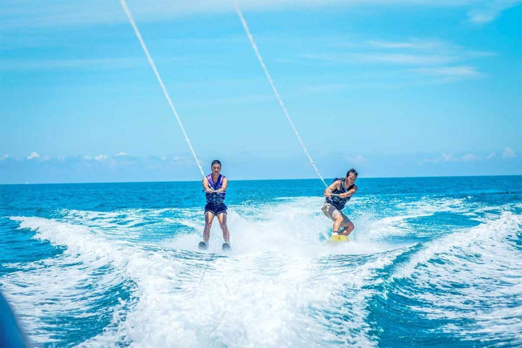 Two guys wakeboarding in the sea of Lang Co Beach organised by a luxury resort