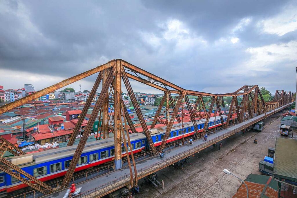 A train is crossing the Long Bien Bridge