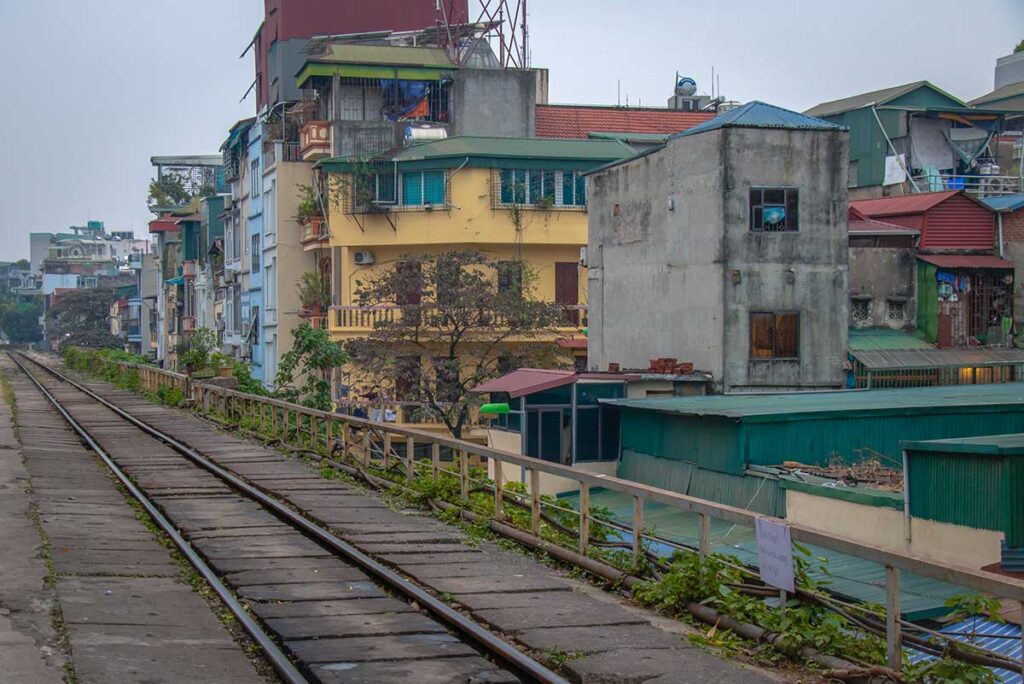 Platform of Long Bien Railway Station with residential houses behind it