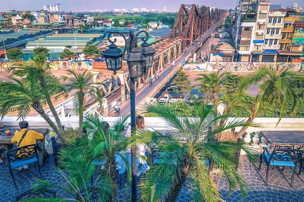 The rooftop area of Serein Café & Lounge were guests are sitting with views on the Long Bien Bridge