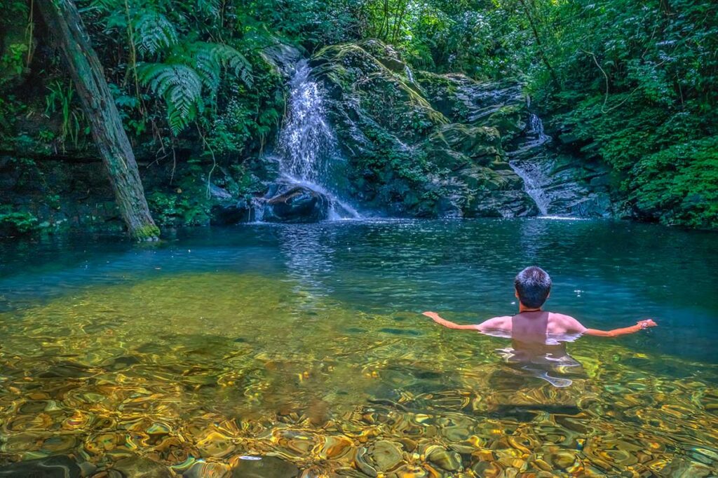 A guy swimming at one of the lake ponds inside Bach Ma National Park