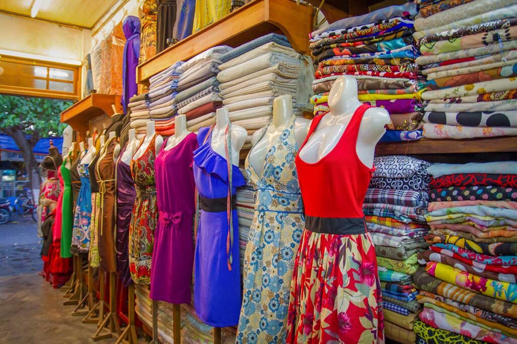 Colorful dresses displayed in a Hoi An tailor shop, representing the variety and creativity of tailor made clothing options available.
