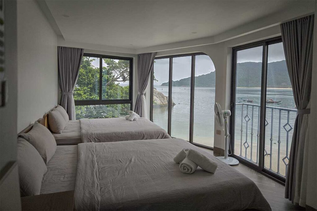 Seaview room at The Coral Homestay on Cham Island overlooking Bai Lang Bay and the surrounding mountains.