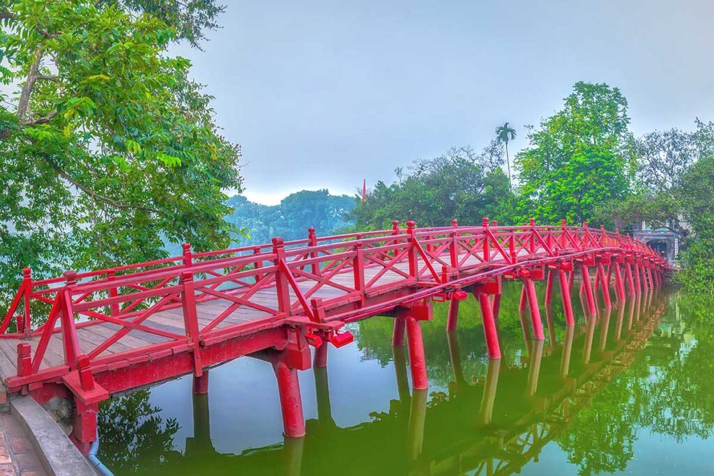 A closeup view of the red The Huc Bridge in Hanoi connecting the lakeshore with Jade Island in Hoan Kiem Lake