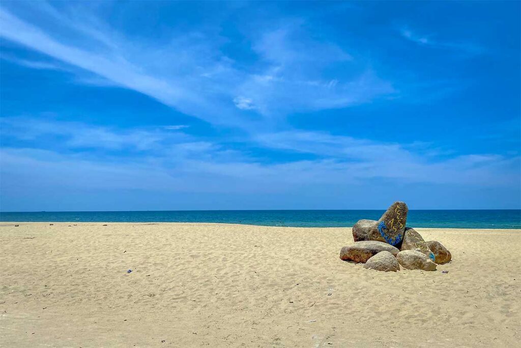 A sunny day with blue sky at Thuan An Beach in Hue with white sand