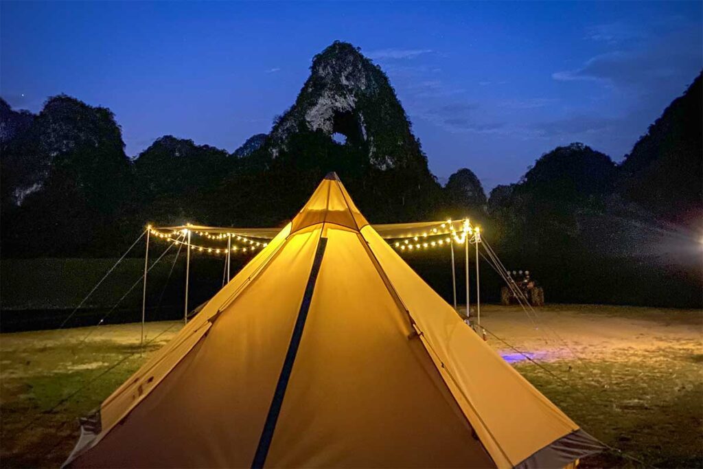 A tent at night with on the background Angel Eye Mountain