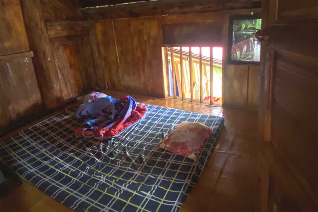 A simple homestay room in Khau Vai with a mattress placed directly on the floor, reflecting traditional rural living.