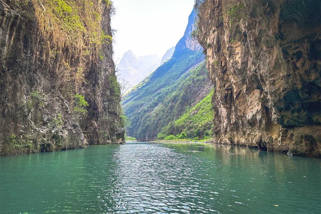 The steep, narrow cliffs of Khau Vai Canyon, where the Nho Que River flows through a dramatic landscape.