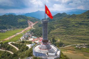 Close-up aerial view of Lung Cu Flag Tower – The Lung Cu Flag Tower, standing tall on Rong Mountain, symbolizing Vietnam’s northernmost point.