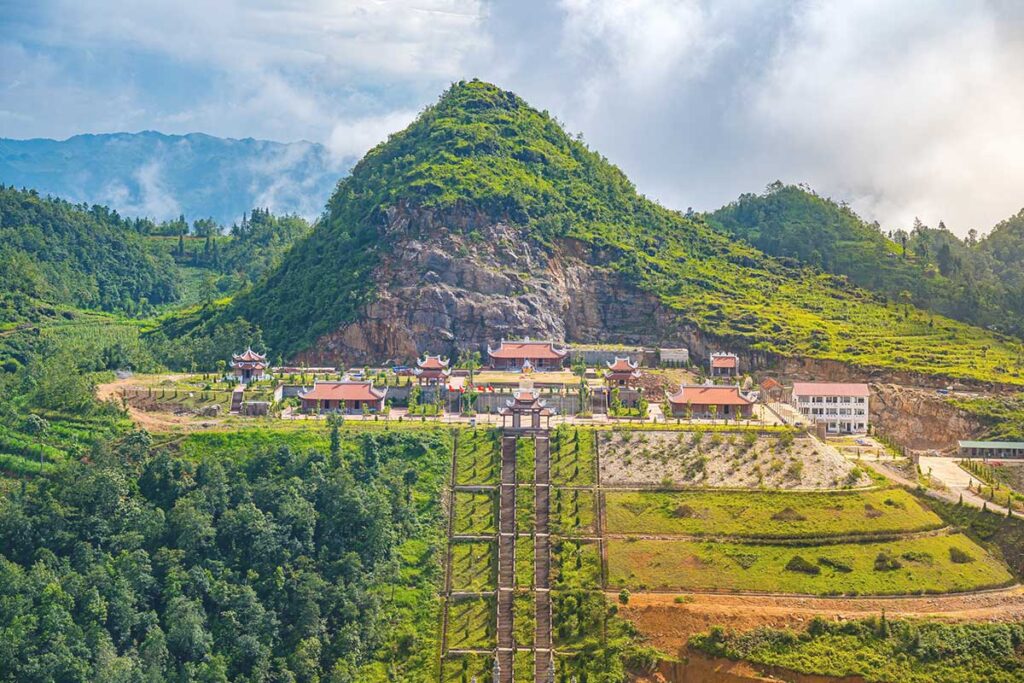 Lung Cu Pagoda (Lung Cu Temple) from Flag Tower – A massive temple complex, now completed, seen from the Lung Cu Flag Tower, standing prominently atop the mountain.