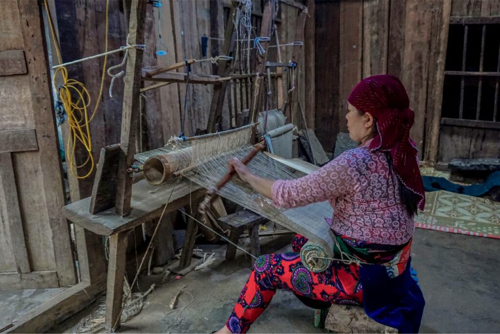 A Hmong woman weaving at Lung Tam Village in Ha Giang