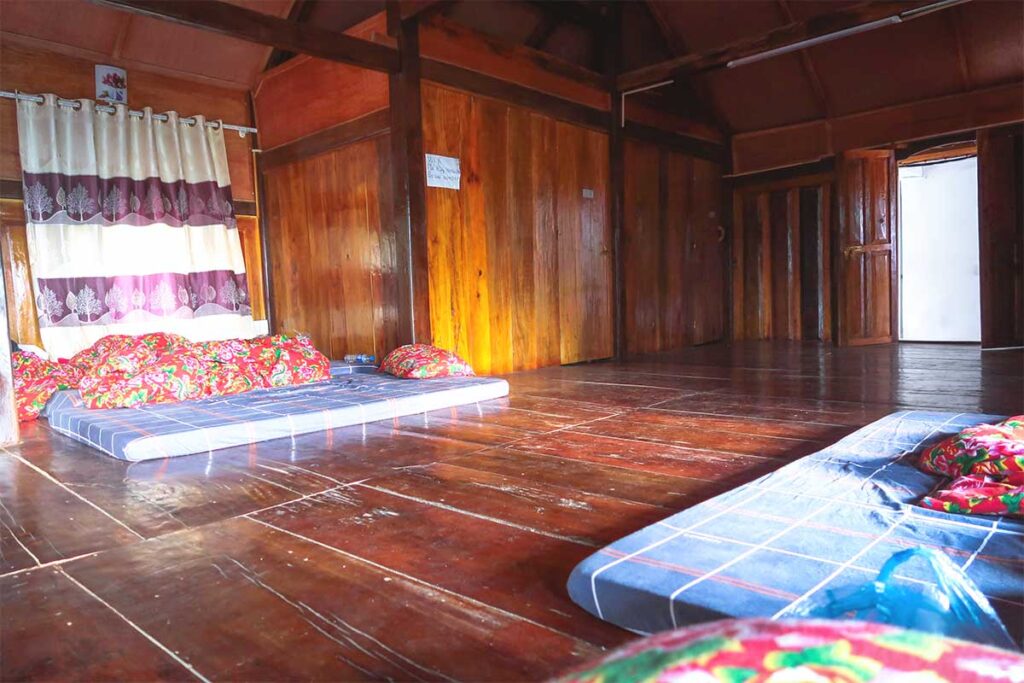 Simple dorm-style room with multiple mattresses on the floor at Ma Pi Leng Homestay in Ha Giang.