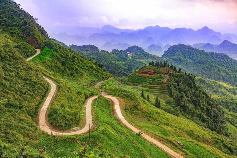 A stunning aerial view of the winding road at Quan Ba Heaven Gate Pass, taken from the highest viewpoint.