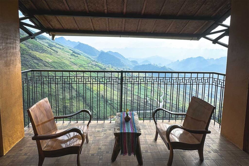 Two chairs inside Tham Ma Retreat with beautiful mountain views in the background
