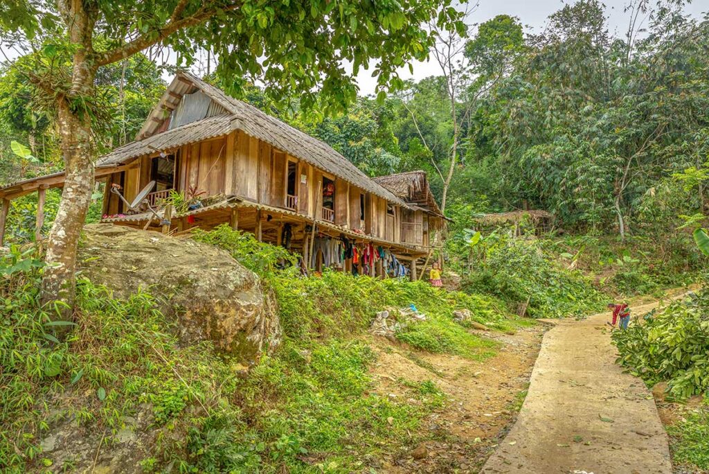 Stilt ethnic house in the middle of the jungle along small path in Pu Luong