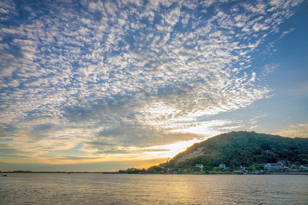 Ngoc Tien Monastery on a hillside above Dong Ho Lake in Ha Tien at dusk.