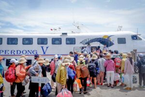 Ha Tien ferry port with passengers boarding boats to Phu Quoc Island.