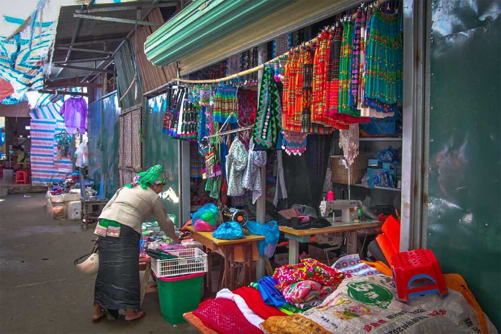 Ethnic woman selling traditional clothes at the Lai Chau Central Market