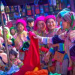 Colorful flower Hmong browsing clothes on the Bac Ha Market