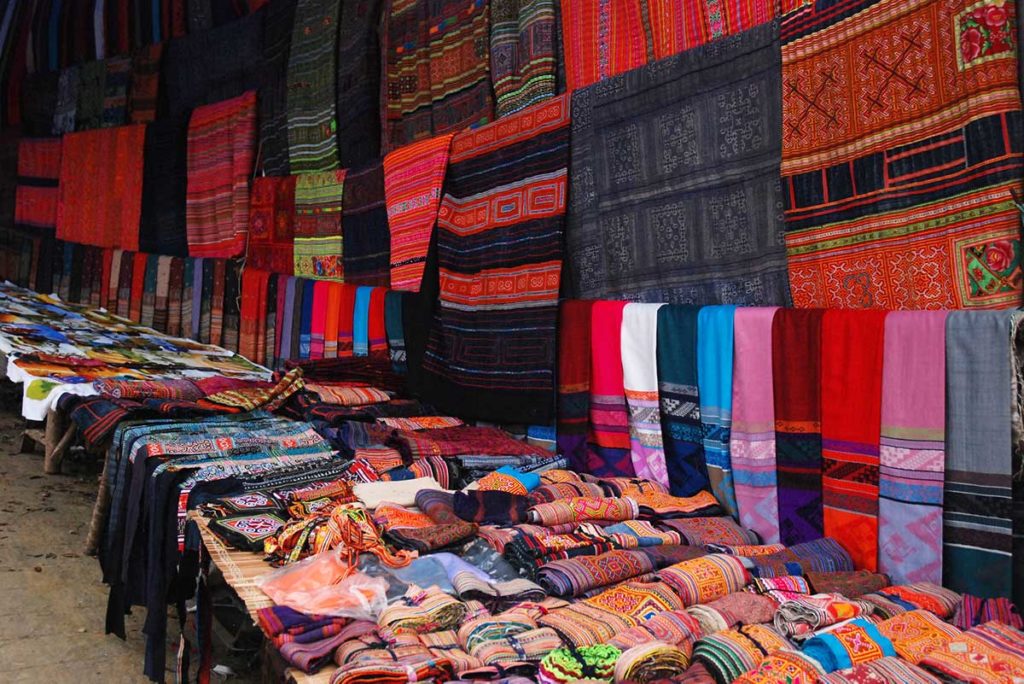 Bac Ha market colorful clothes at market stalls