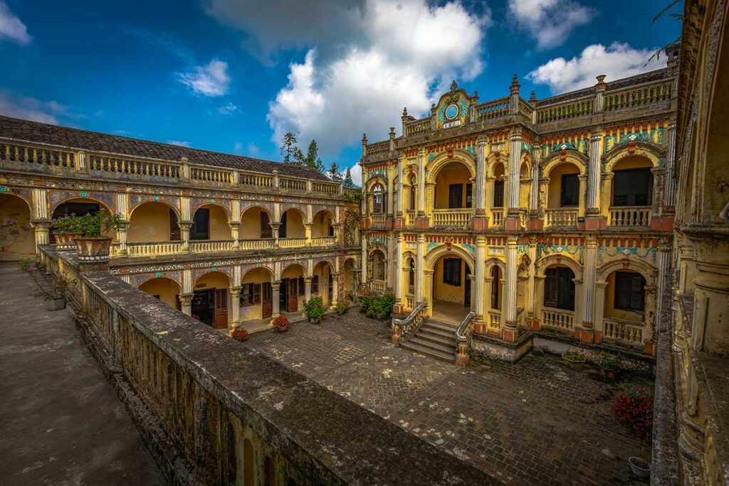 The indoor courtyard and yellow walls of the Hmong Kings Village in Bac Ha called Hoang A Tuong Royal Palace