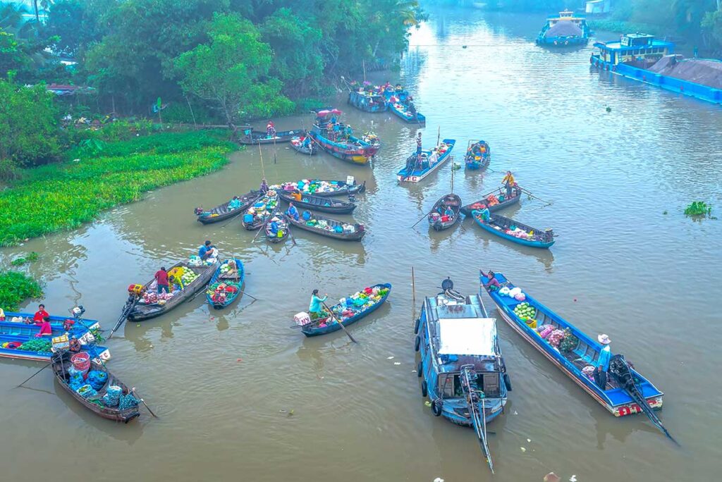Phong Dien Floating Market seen from the bridge near Can Tho, with wooden boats selling fruit and vegetables on the Hau River.