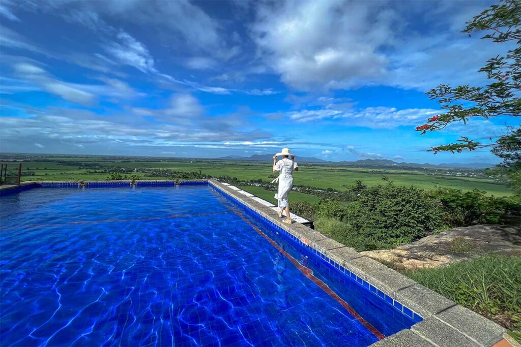 Infinity pool at Victoria Nui Sam Lodge, overlooking rice fields and mountains in Chau Doc, An Giang.