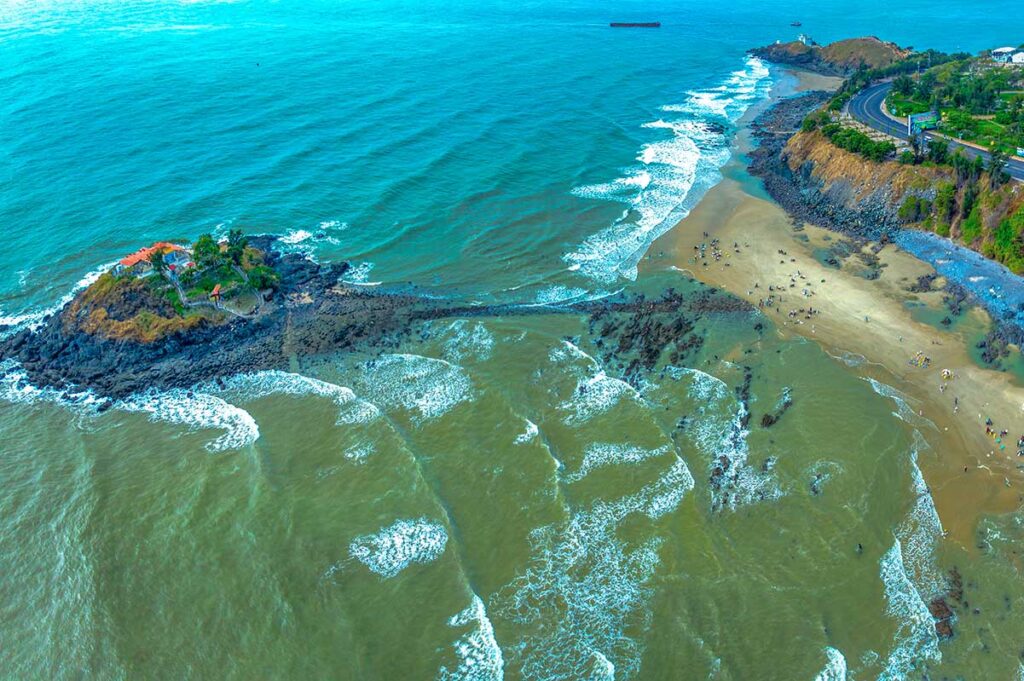 Aerial view of the coast of Vung Tau and Hong Ba Island and temple during low tide with a rocky path appearing 