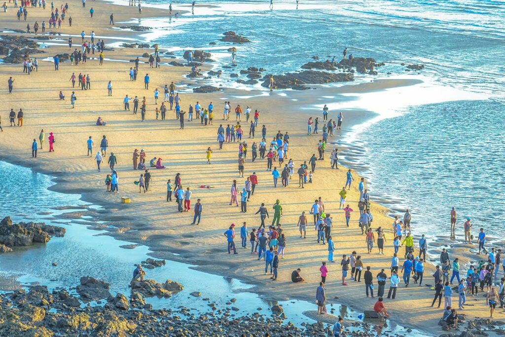Crowds on the beach of Vung Tau waiting to cross to Hon Ba Temple on the island off the coast