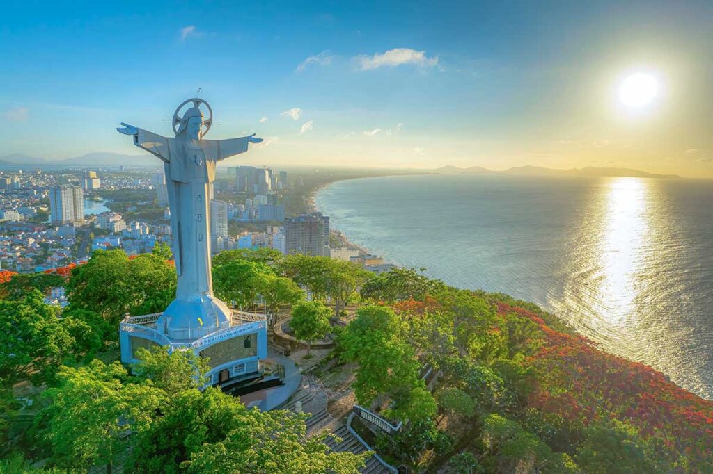 Aerial view of Jesus Christ Statue Vung Tau with the coast line and city Vung Tau in the background