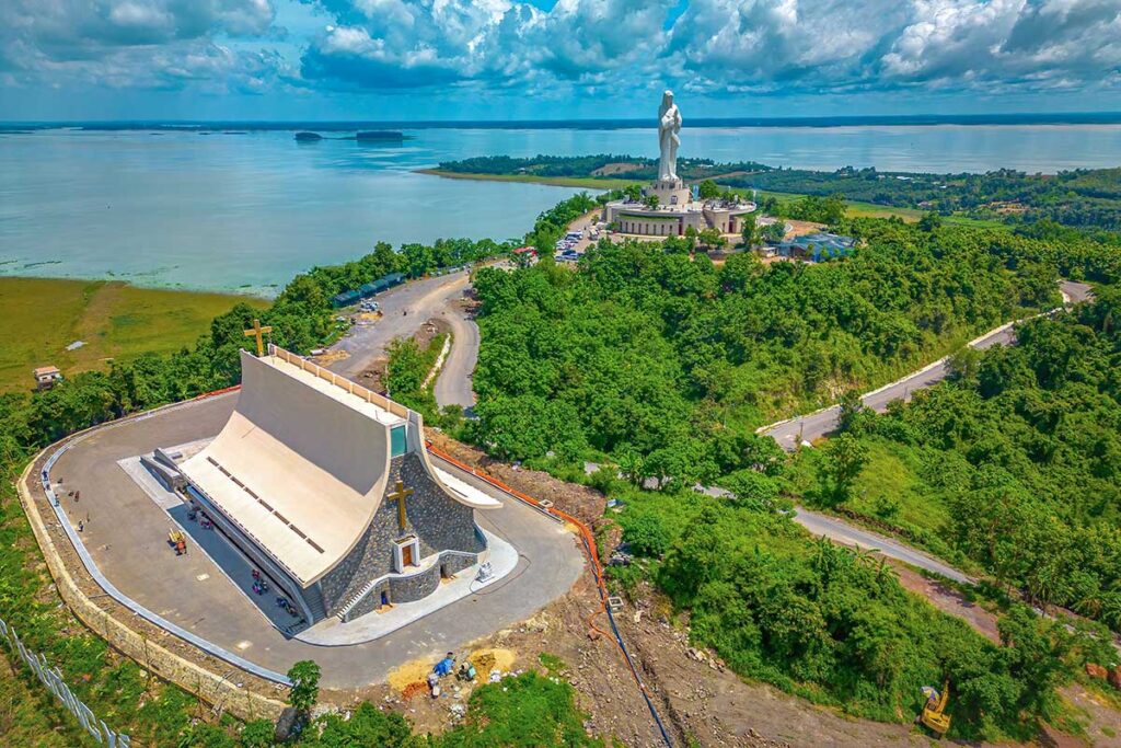 Aerial view of Our Lady of Nui Cui Pilgrimage Center with in the back Tri An Lake