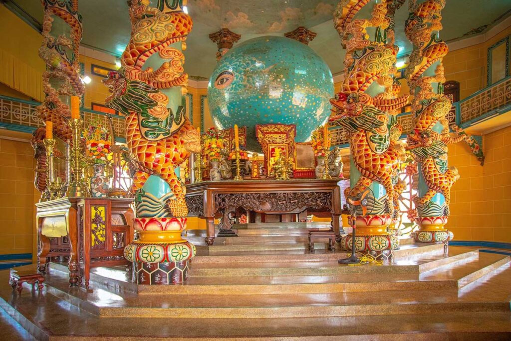 An altar and globe with the all seeing eye inside the Cao Dai temple in Tay Ninh